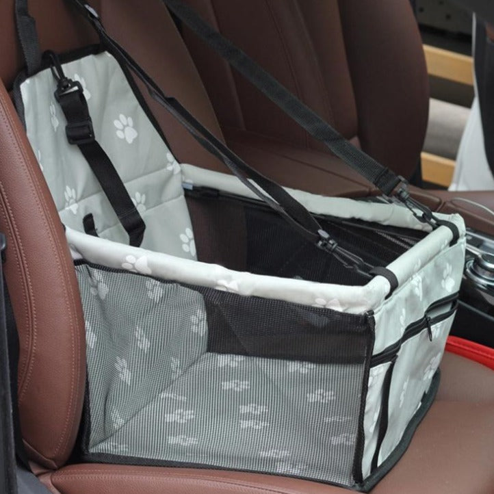 Pet car hammock seat, light gray with white paw print pattern and black securing straps