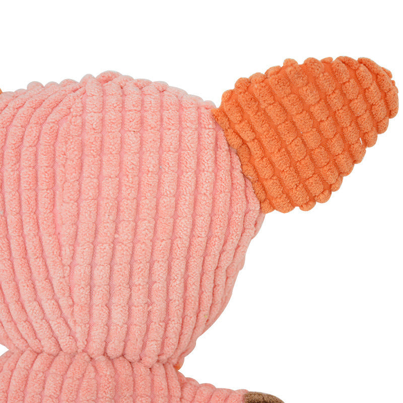 Pink and orange ribbed plush toy head with stitched ridges and embroidered face