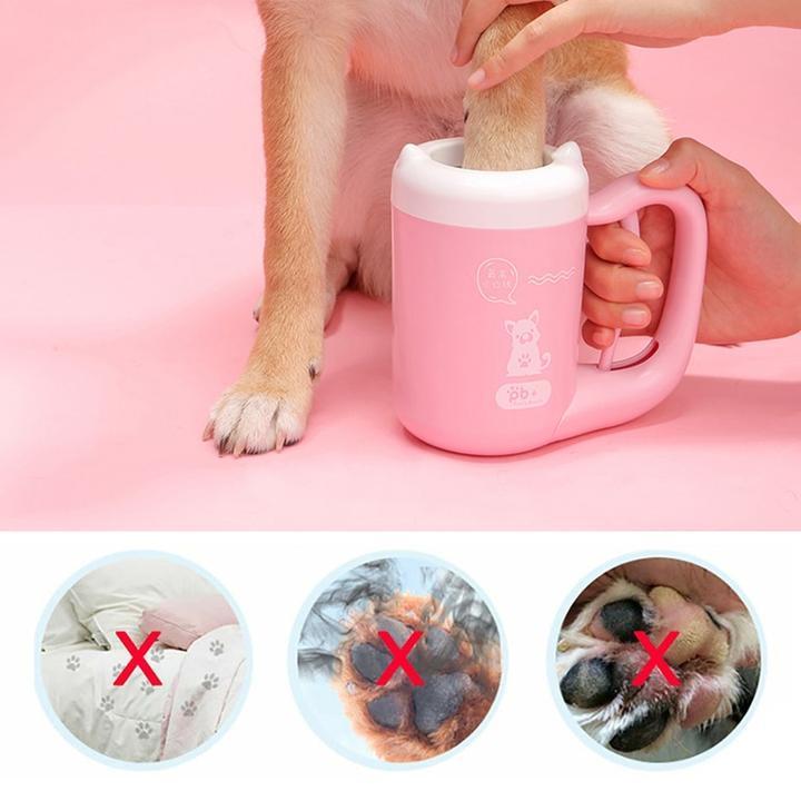 Pink portable paw-cleaning cup used to clean a dog's paw with brush