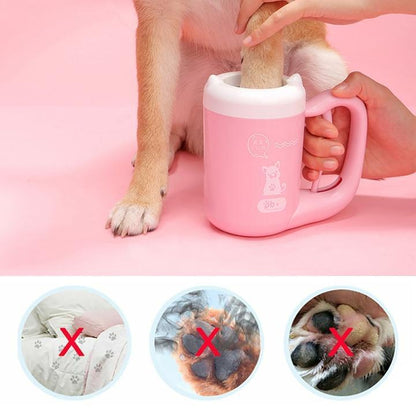 Pink portable paw-cleaning cup used to clean a dog's paw with brush