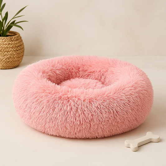 Pink plush donut pet bed with raised rim and round inner cushion hollow center