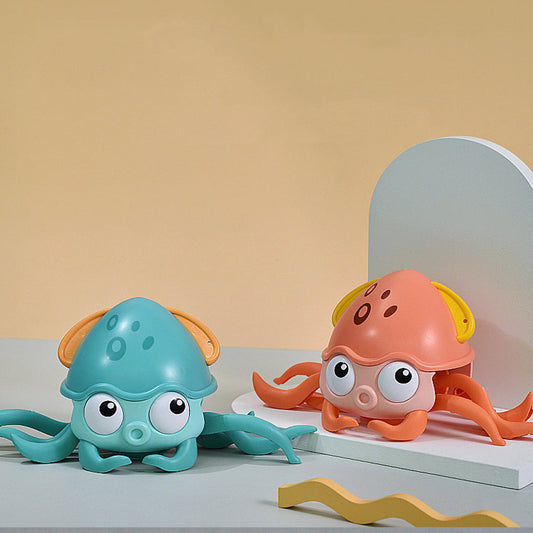 Blue crawling baby octopus bath toy with orange side loops and wide eyes