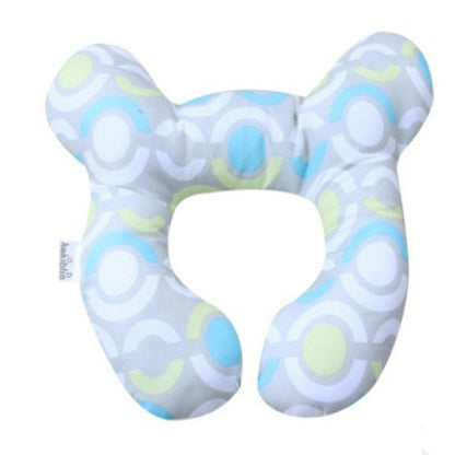 U-shaped baby head support pillow with light blue cover and circular swirl pattern