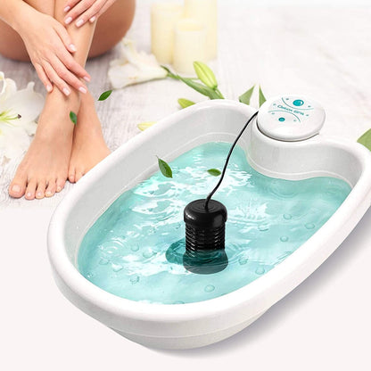Foot spa machine with teal basin water, control unit on rim, black electrode
