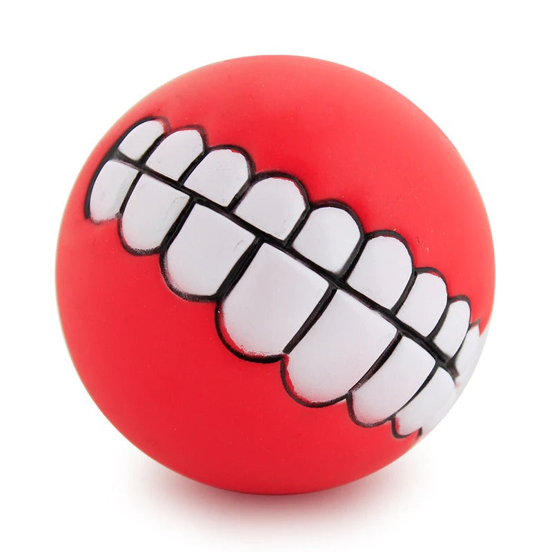 Red rubber pet teeth squeaky ball with white outlined tooth row detail.