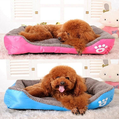 Waterproof fleece pet bed with gray inner cushion and pink outer cover with paw-print