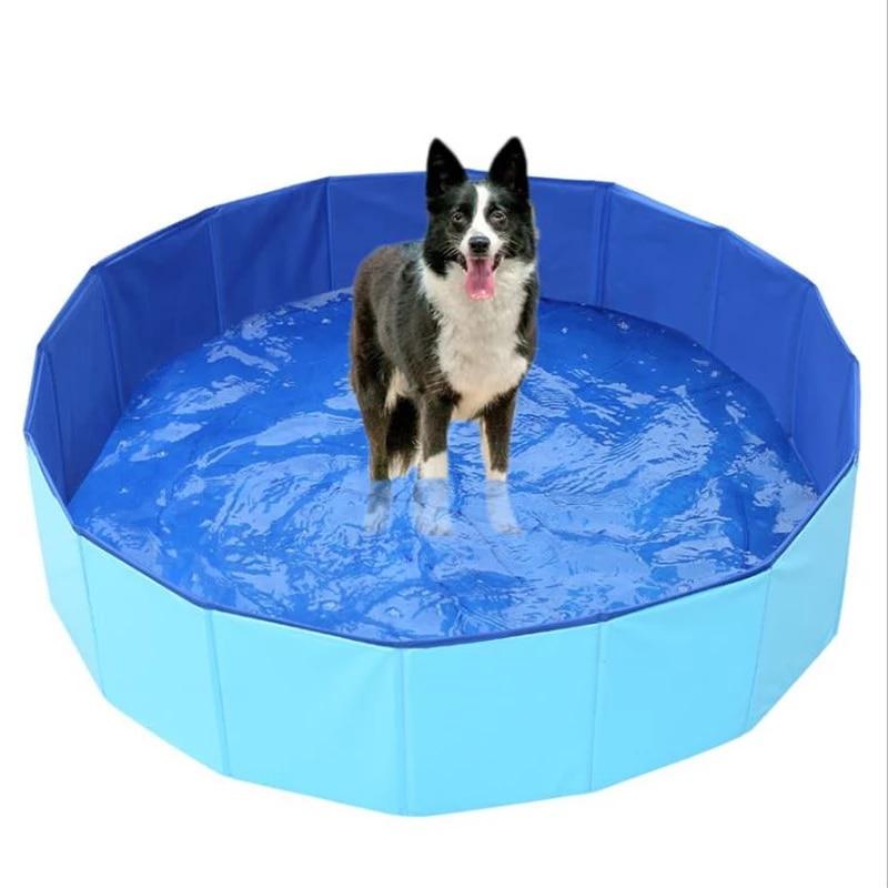 Foldable pet swimming pool with light blue sides, dark blue liner, and pet inside
