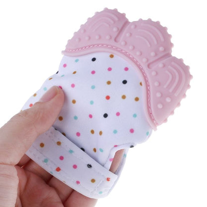 Pink and white teething mitten glove held in hand, dotted fabric and textured back