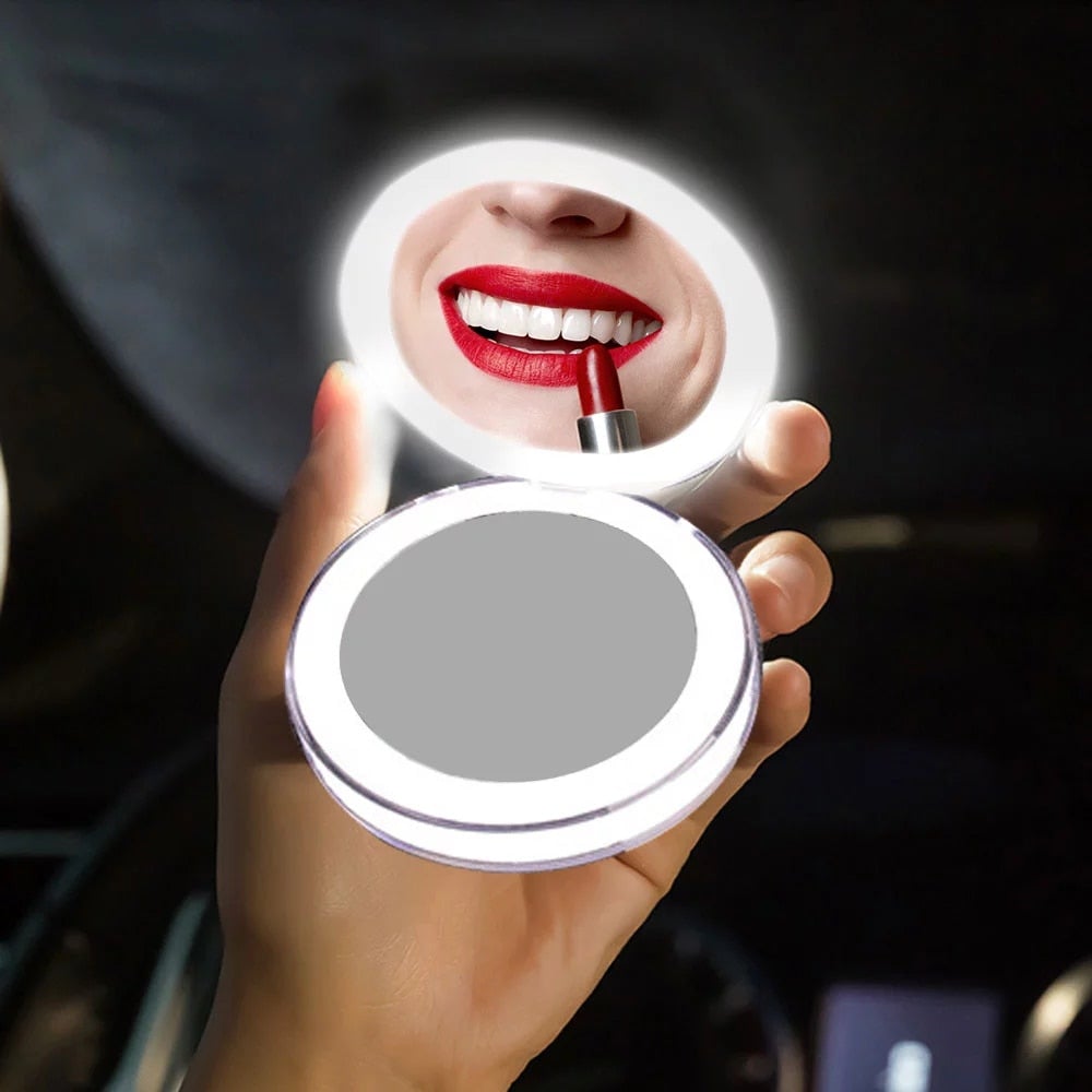 Handheld round makeup mirror showing bright LED glow