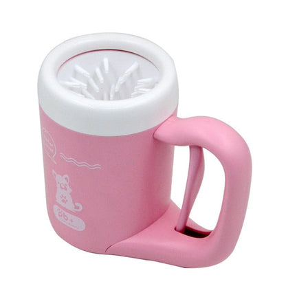 Pink portable dog paw-cleaning cup with white rim and visible bristle brush