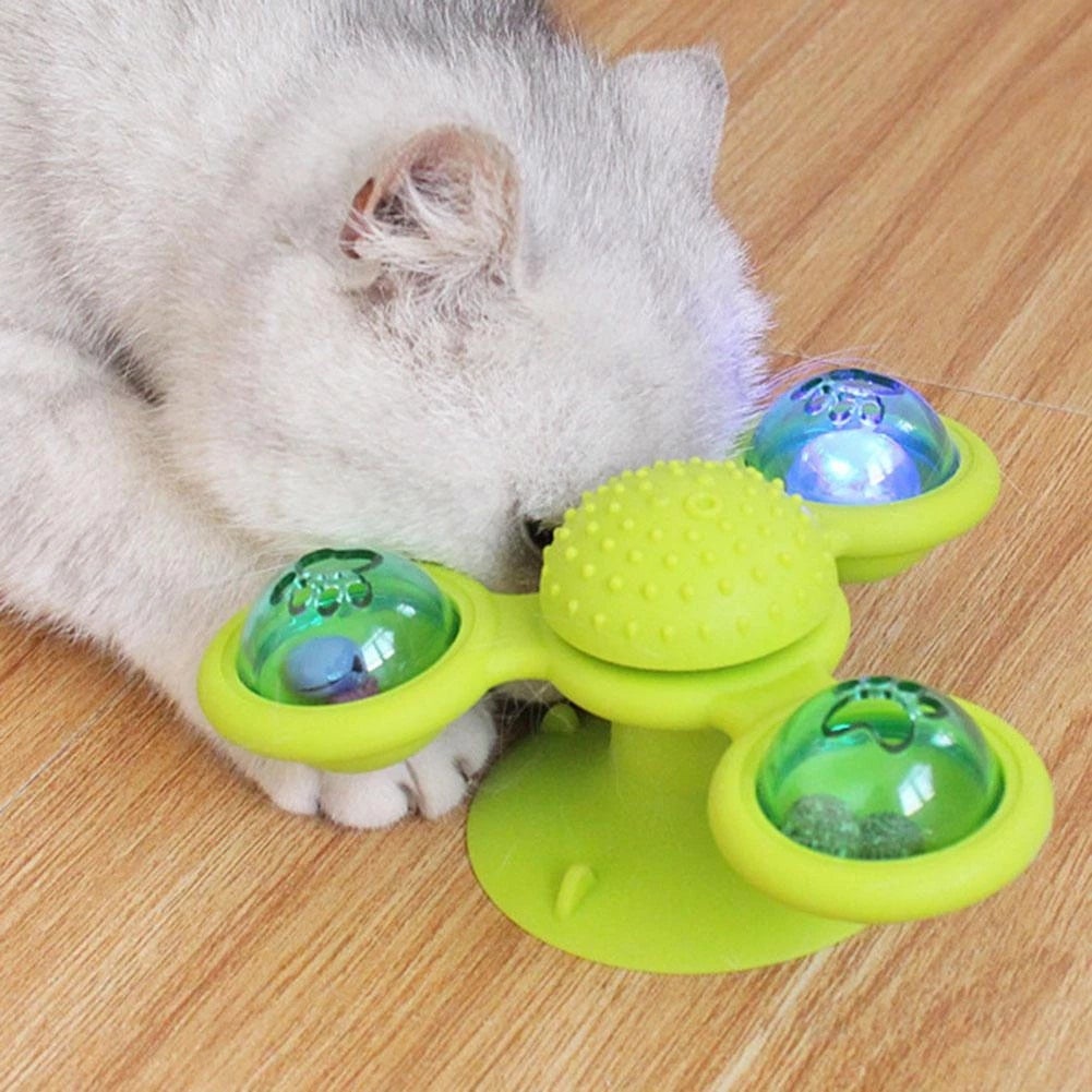 Green and yellow scratch windmill cat toy with blue light pods and spiky dome
