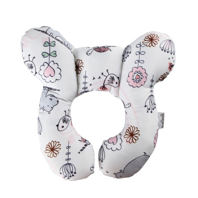 U-shaped baby head support pillow in white with pastel flowers and doodle animals