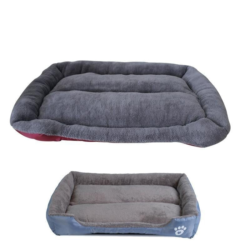 Waterproof fleece pet bed in dark gray with blue base edge and paw-print patch