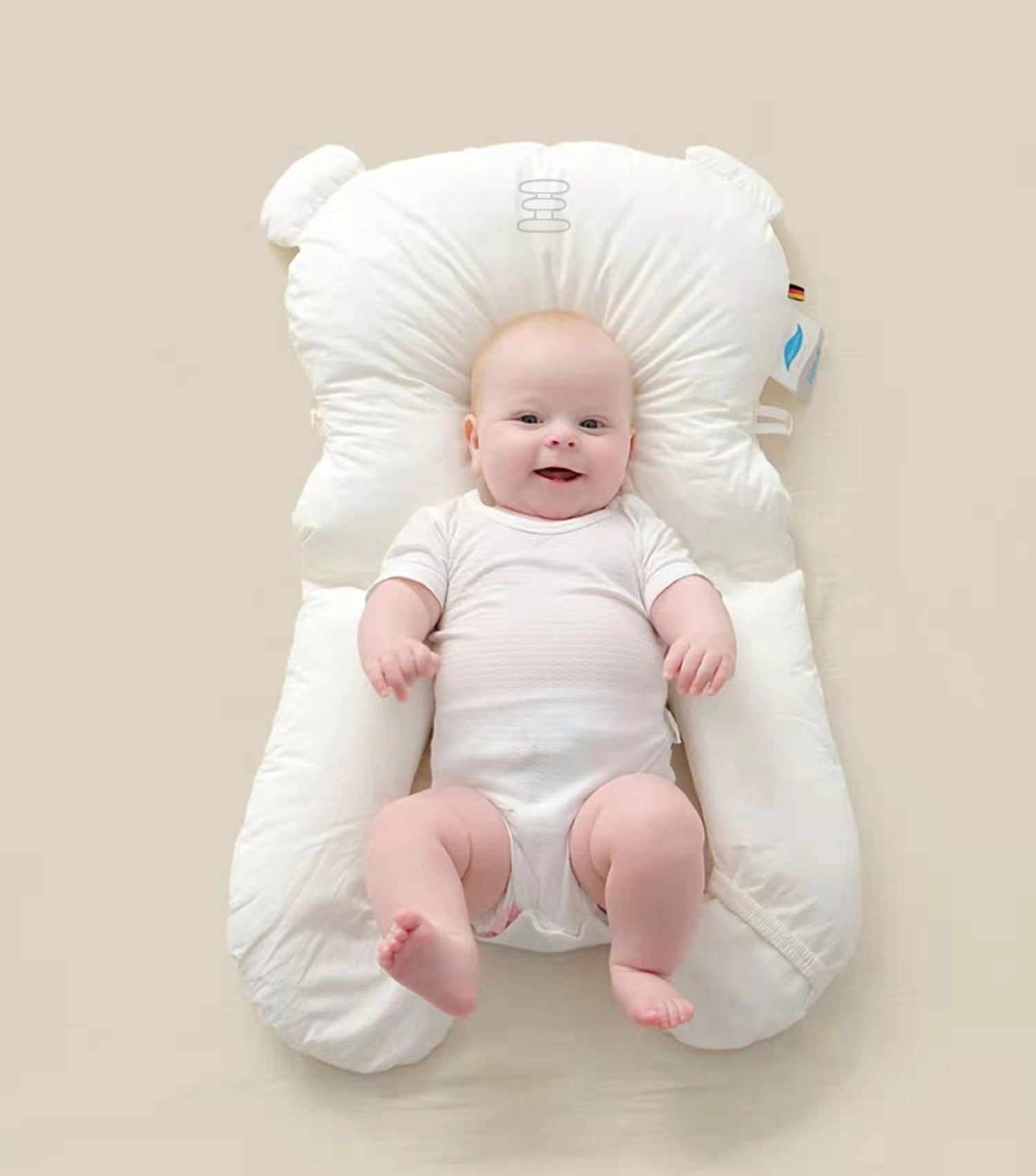 Newborn head shaping pillow with cushioned neck cutout, supporting an infant lying down