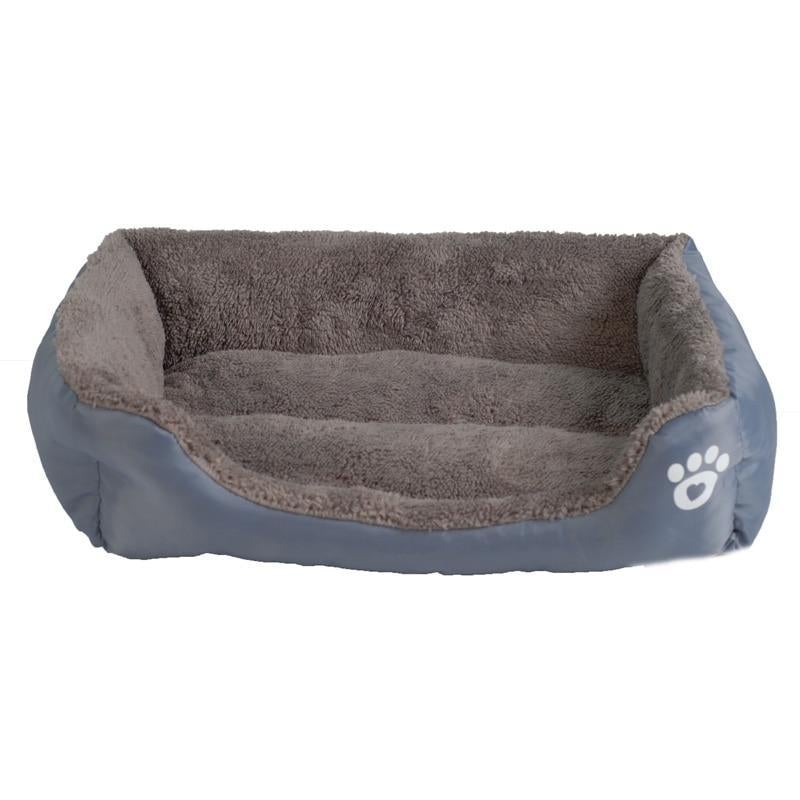 Waterproof fleece pet bed in blue with gray inner cushion and white paw-print patch