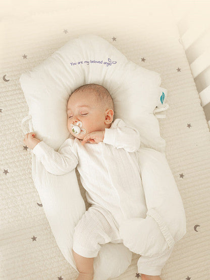Newborn head shaping pillow, white plush cradle with head opening and neck support for comfort