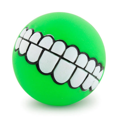 Green rubber pet teeth squeaky ball with white outlined tooth row detail.