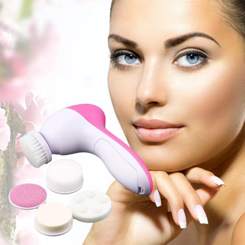 Pink and white electric facial cleansing brush with several circular cleansing pads