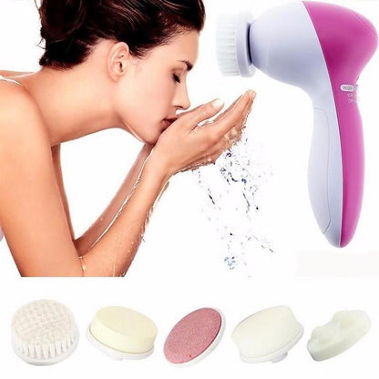 Electric facial cleansing brush with pink handle and included cleansing pads